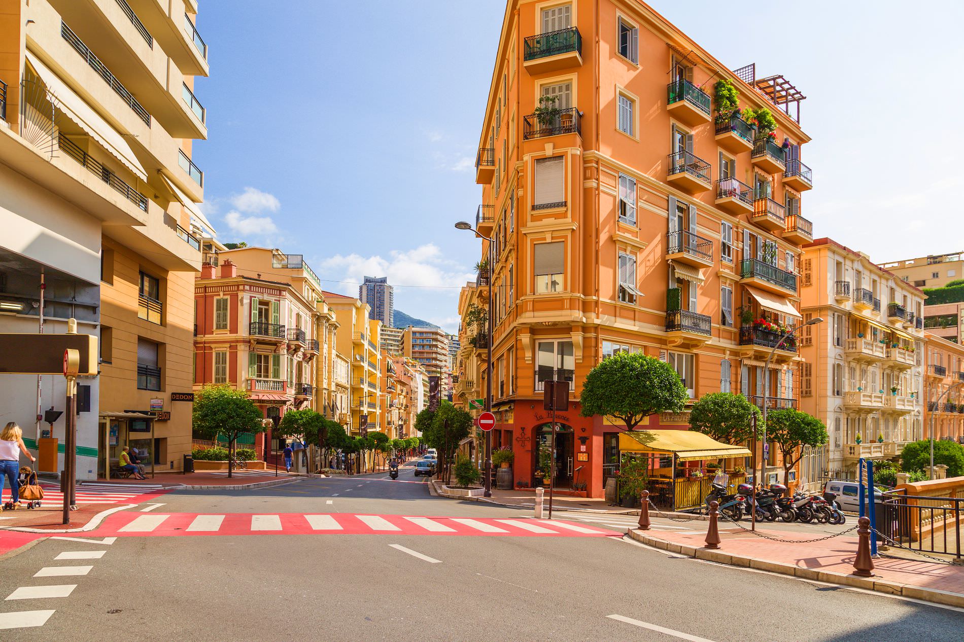 Corner buildings and café terraces on Rue Grimaldi in La Condamine Monaco