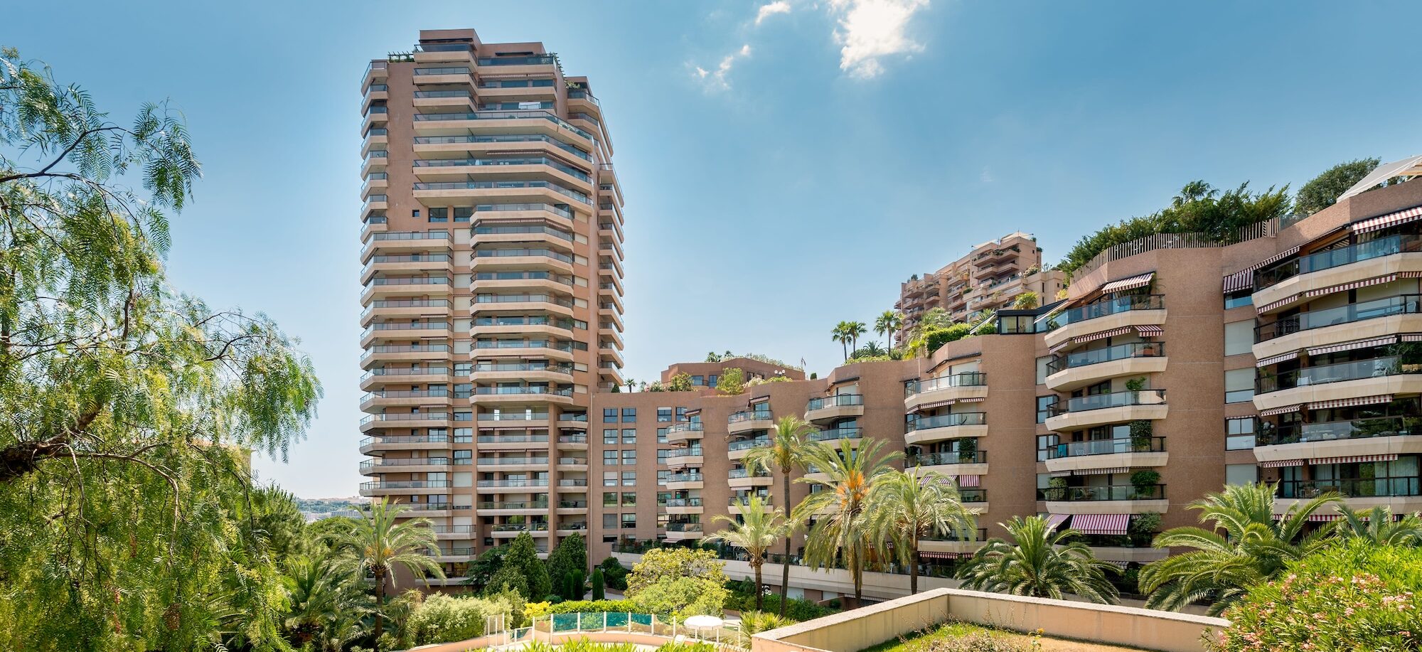 Green spaces in the courtyard of Monte Carlo Sun, the same building rising in the background