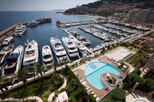 View over Monaco harbour with yachts and the Palazzo Leonardo swimming pool terrace overlooking the marina
