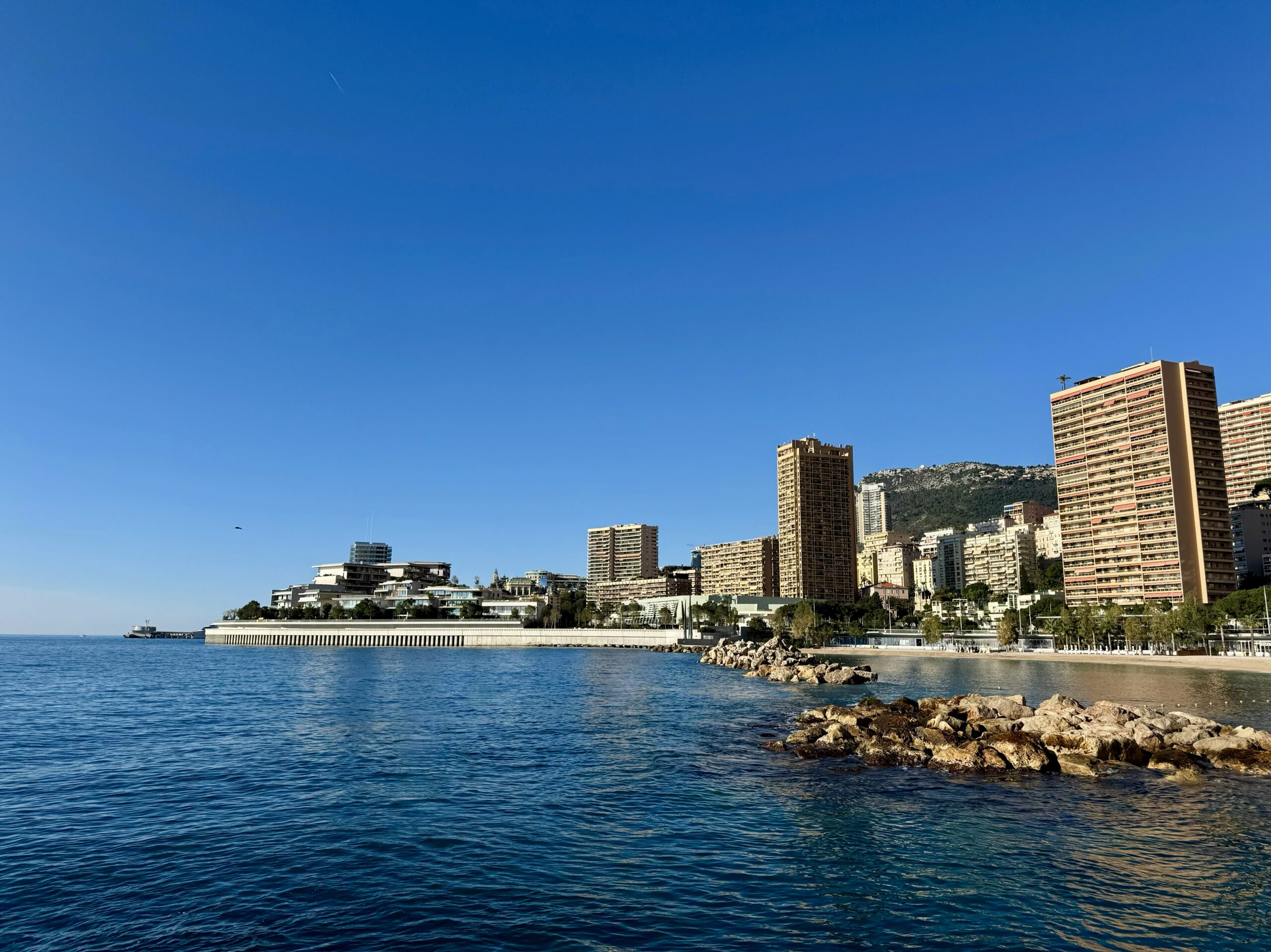 Larvotto beach pictured on a sunny day with blue in front